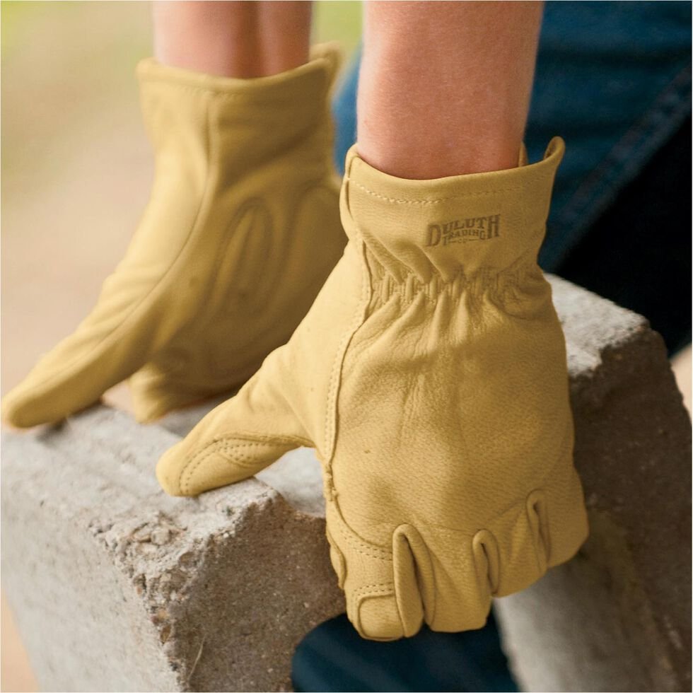 person wearing a pair of leather gloves