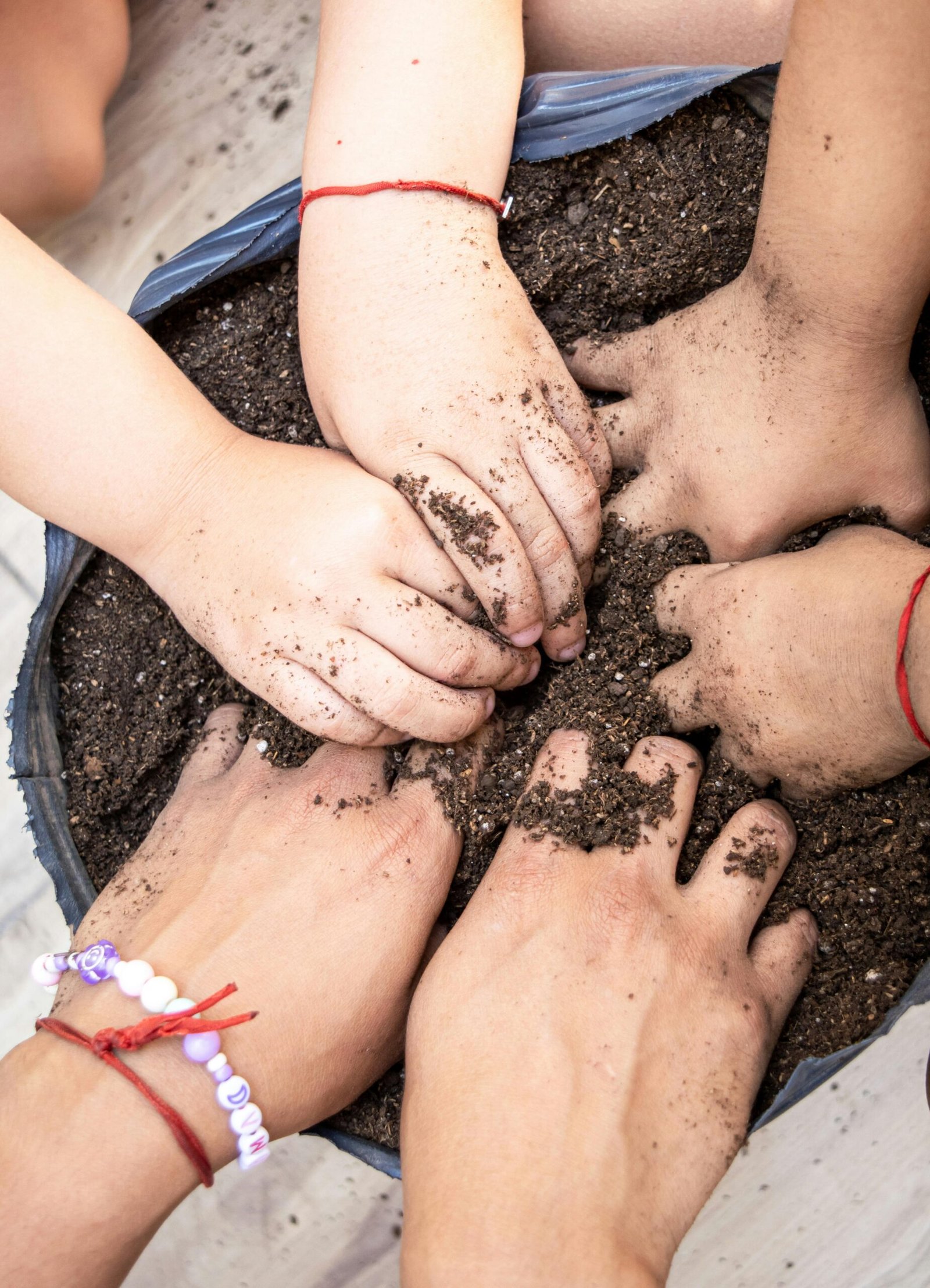 little hands playing in gardening soil